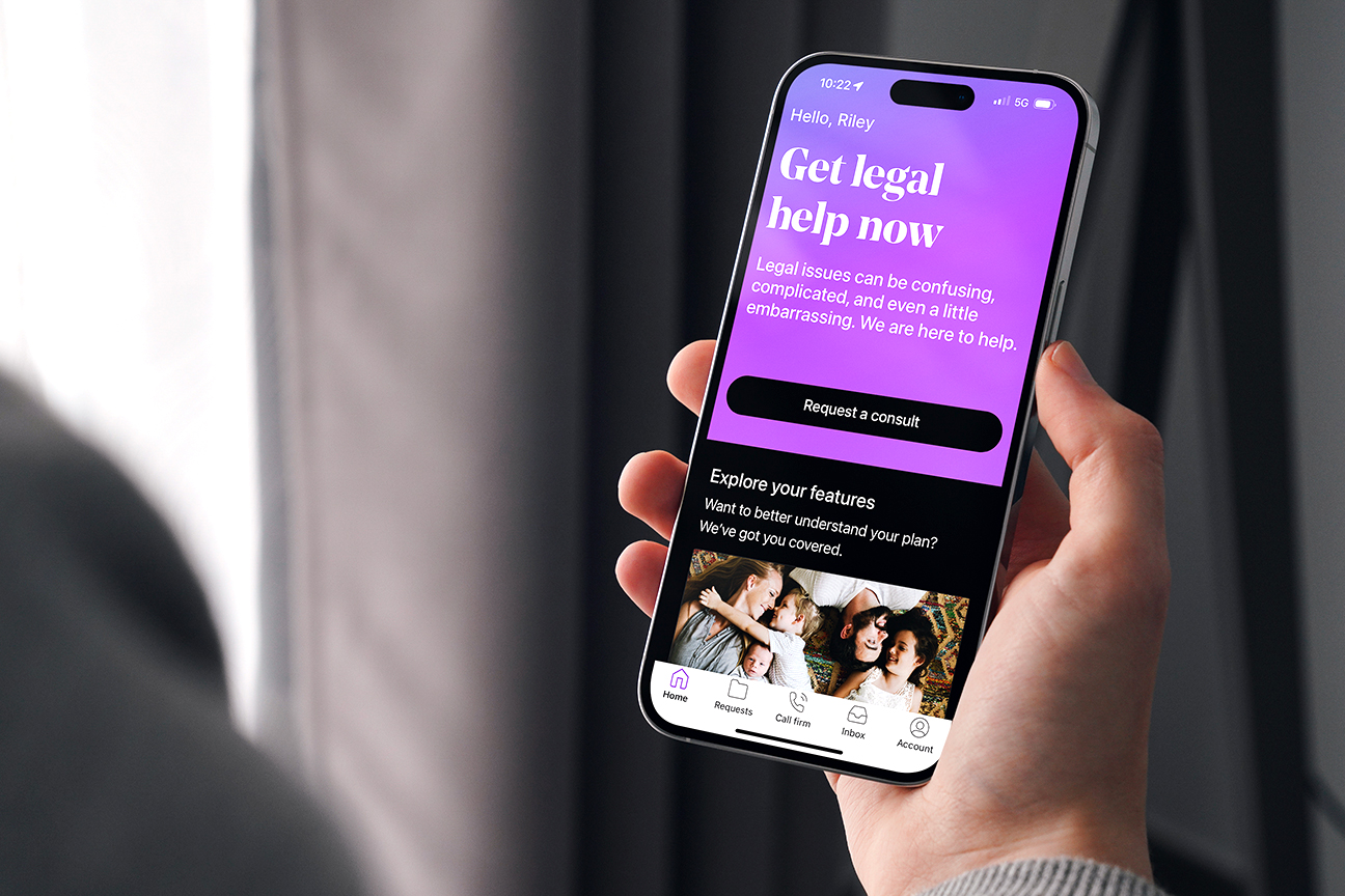 Man holding phone with LegalShield app on the screen.